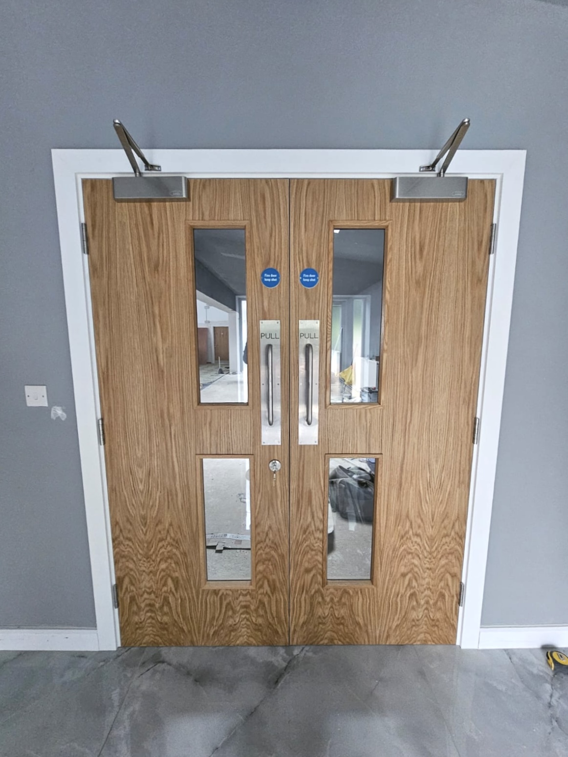 Timber commercial double doors with glazed vision panels